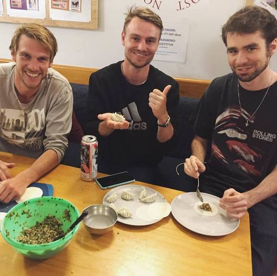 Happy hostel guests smile over gyoza