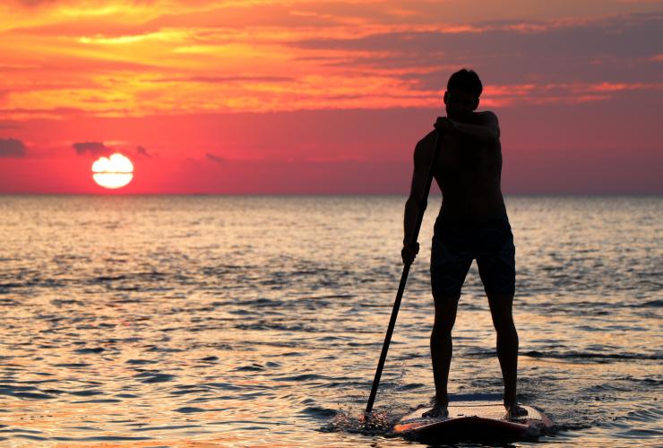 Check out the SUP athletes in the Red Bull Heavy Water SUP paddler in sunset