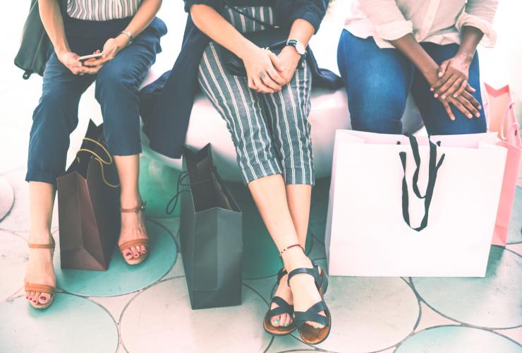 Can't lose with hopping and beer! three woman sitting with shopping bags